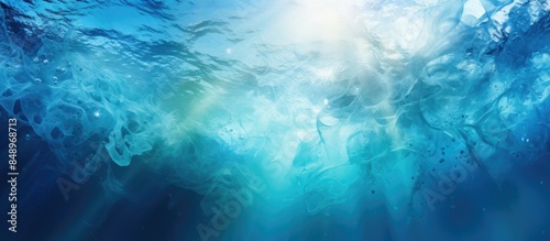 Underwater world in shades of cyan and dark marine blue with ink spreading through water enhanced by light casting circular gradients and depth ideal for copy space image