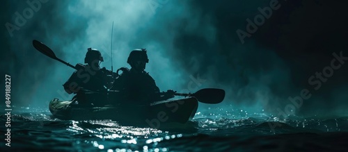 Two special forces soldiers in the military kayak. Diversionary mission under cover of darkness