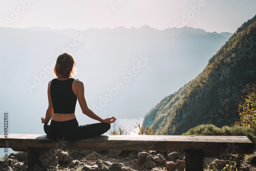 Young woman is meditating in mountains.