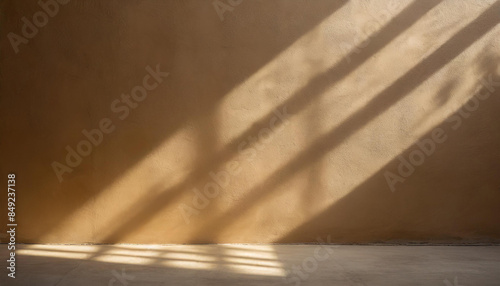 minimalistic background of empty beige brown wall with sun rays for presentation, texture