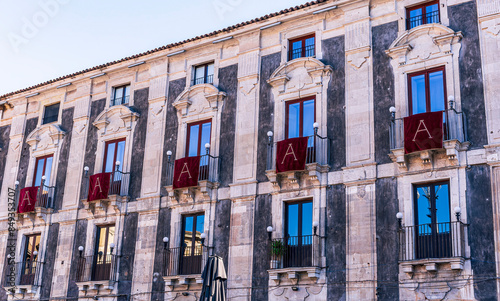 window with red banner or pennant with letter A for decotarion of old building facade