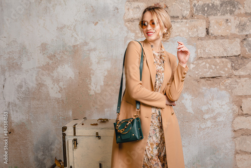 attractive stylish blonde woman in beige coat, spring autumn fashion trend