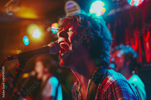 Energetic live band performance with lead singer passionately singing on stage, under vibrant colorful stage lights.