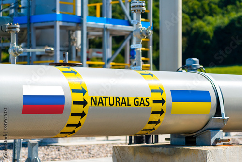 Natural gas pipeline showing the direction of gas flow from Russia to Ukraine. Russian and Ukrainian flags showing concept of gas export from Russia to Ukraine