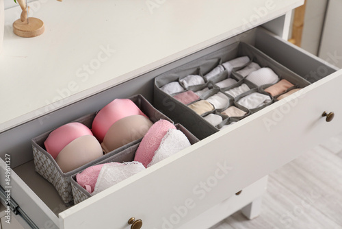 Open drawer with clean clothes in room, closeup