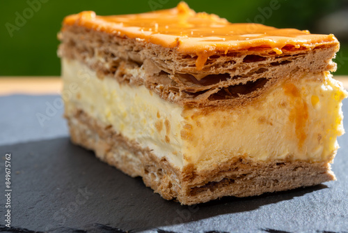 Celebration of the King birthday in Netherlands, tompoes or tompouce, iconic pastry in Netherlands made from puff dough, orange icing, cream