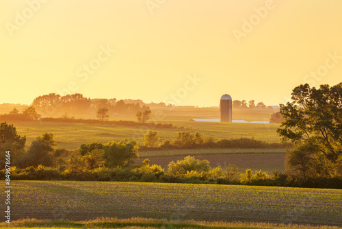 Farm and fields and trees at sunset in northeastern Iowa during the late spring