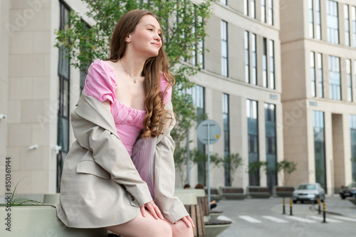 A teenage girl walks in the city