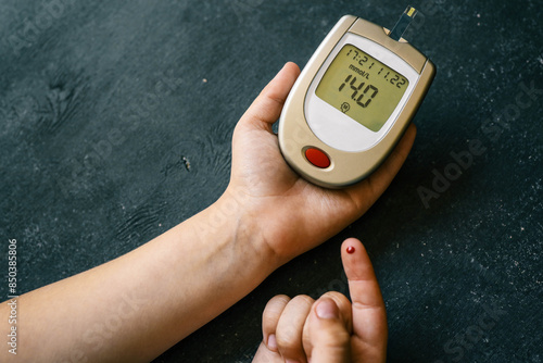 Close-up Of Woman Hands Testing High Blood Sugar With Glucometer