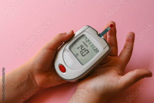 Close-up Of Woman Hands Testing High Blood Sugar With Glucometer