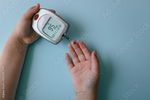 Child measuring blood sugar level