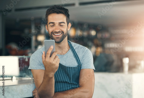 Barista, man and mobile phone in cafe with apron for communication, networking or restaurant app. Connection, small business owner and male person for social media, browsing internet or online order