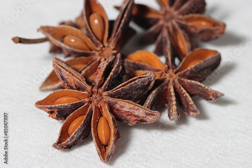 Star anise. Some star anise fruits with seed. Macro close-up on the jute burlap surface in rustic style.