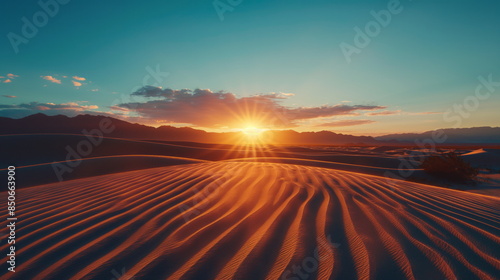 Captivating sunset illuminates the rippled sand dunes of a vast desert landscape, creating a vibrant orange glow