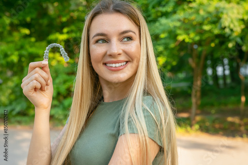 Woman with perfect smile after invisible dental aligners aligners treatment