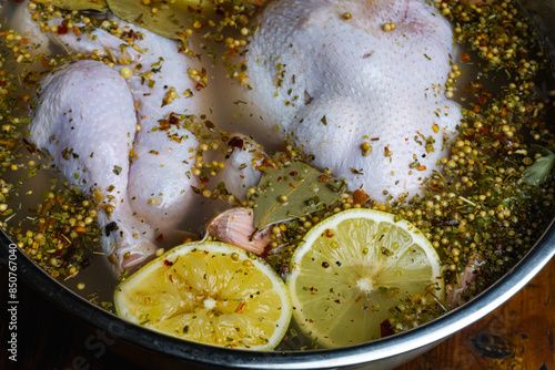 Soaking the chicken in a brine solution using lemon, herbs and aromatic