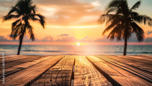 Foreground empty wooden table with a blurred background of a tropical beach in summer, complete with coconut palms. Spacious area on the table for summer product advertisements and presentations.