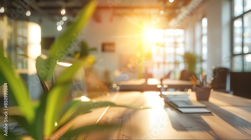 Blurred view of a spacious office, morning light softening the modern lines and creating a productive ambiance