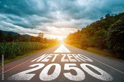 On the road there is an arrow pointing ahead and the letters NET ZERO by 2050 to campaign to stop greenhouse gas emissions. Reduce carbon dioxide emissions from vehicles and industrial plants.