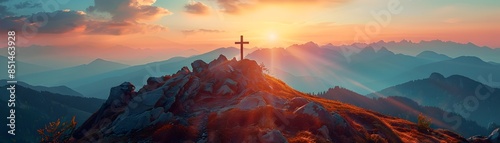 Sunset Silhouette of a Summit Cross Crowning a Rugged Mountain Landscape
