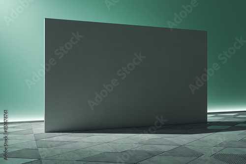 An empty modern room with a large grey wall and patterned floor, in a cool greenish light background, illustrating a minimalist design concept. 3D Rendering