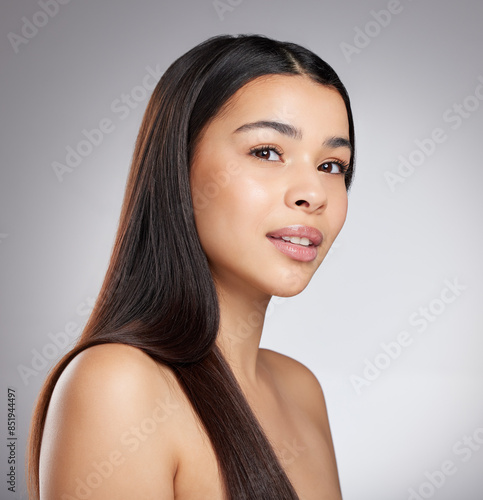 Hair care, glow or woman with beauty, portrait or style for confidence, results or keratin treatment. Face, shine or girl model in studio on grey background for wellness, natural growth or cosmetics