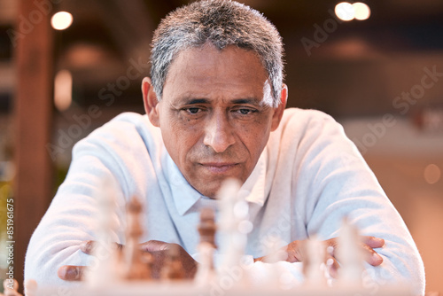 Mature man, thinking and strategy in chess for game, challenge or sport for healthy mind, practice and ideas. Male person, playing and planning for move or gambit as master in decision, play on board