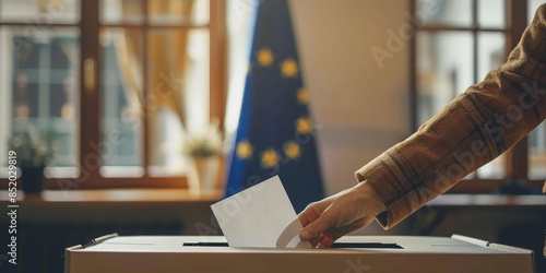 President governmental election giving your voice voting concept. Unrecognizable man putting their vote in the ballot box with European Union flag on background