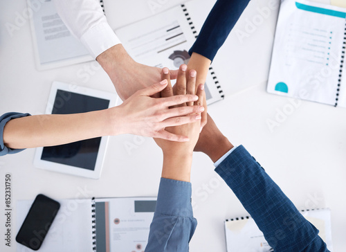 Teamwork, documents and business people with hands in stack for community and inclusion support in office above. Employee group synergy, paperwork and palm huddle with collaboration and team building