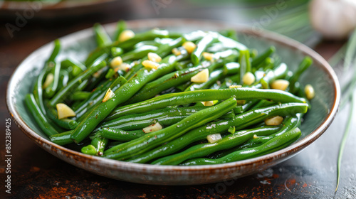 A plate of green beans with garlic and salt