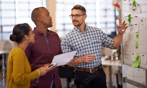 Business people, whiteboard and schedule with planning, teamwork and share ideas with newsroom. Research, employees and staff with project, talking and cooperation with copywriting or creative agency