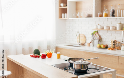 A kitchen featuring a stove top oven placed next to a counter. The stove is equipped with burners and knobs, while the counter offers space for food preparation