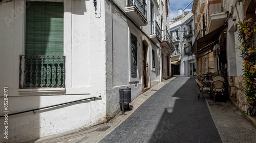 Quiet European alleyway with traditional architecture and closed shutters, evocative of siesta time and Mediterranean lifestyle