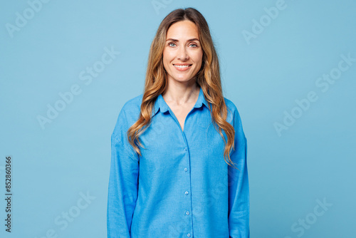 Young smiling happy cheerful satisfied fun cool European woman she wearing shirt casual clothes looking camera isolated on plain pastel light blue cyan background studio portrait. Lifestyle concept.