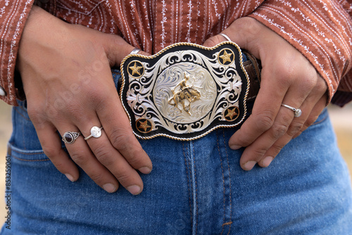 Close-up of a rodeo belt buckle worn by a female ranch hand, or cowgirl.