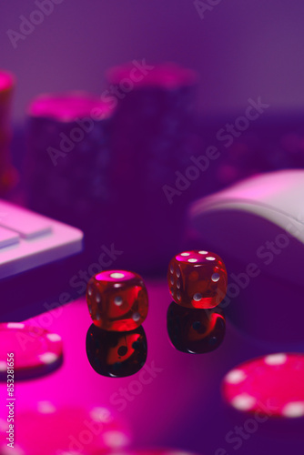 Red Dice on a Pink Surface With a Computer Keyboard and Mouse