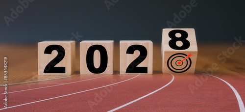 Multi exposure of running track and wooden cube 2028 target board new year in concept of action business plan targets the new year 2028 growth