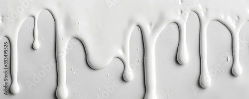 white liquid dripping on white background