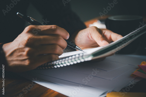 Student is diligently writing in notebook during tutoring session, preparing for exams. education and the detailed work involved in studying and writing reports and letters.