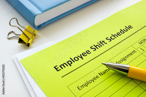 Employee shift schedule form and pen.