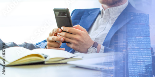 Close up, business man using mobile smart phone on wooden table. man using smartphone during working at office with digital tablet on table, social network, business success 
