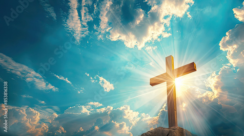 holy sunlight shining on the Christ wooden cross symbol with religious clouds on blue sky background