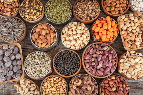 Assorted nuts and seeds background. mixed raw food for snacking, top view. different nuts background. Collage nuts and seeds in shell, top view. assorted healthy food background.