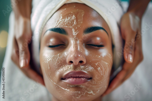 Close up of a black woman having a facial massage in a spa