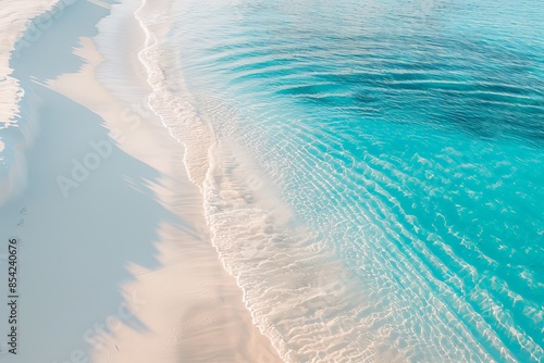 Turquoise water gently lapping pristine white sand beach