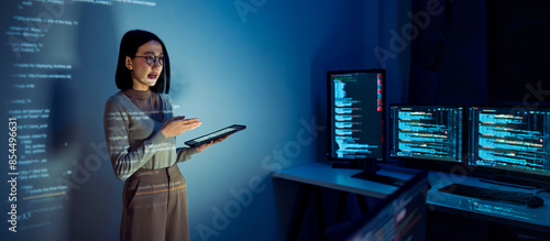 asian woman programmer standing in front of a screen with code projected presentation the integration of technology and human expertise in software development
