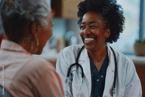 In a hospital setting, a black woman or doctor gives care feedback or support to a patient. Smile, a nurse or doctor talks about test results or advice with a mature individual.