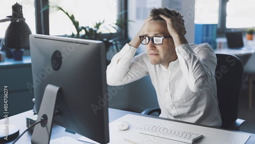 Panicked businessman having issues with his computer