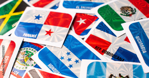 High angle view of different central america country flag stickers on table 