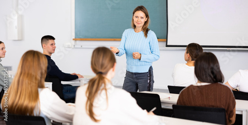 Female teacher teaching high school students in a school classroom